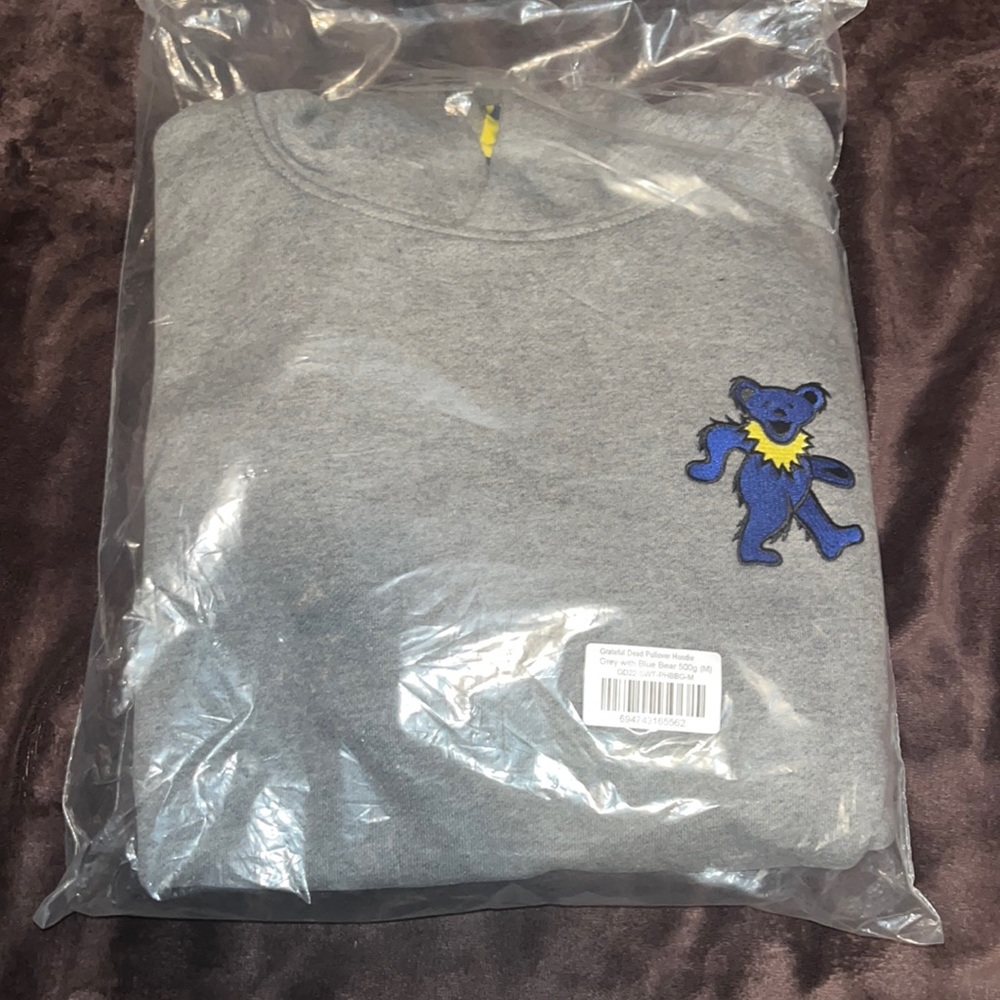 Grey medium pull over hoodie with blue Greatful dead bear on it